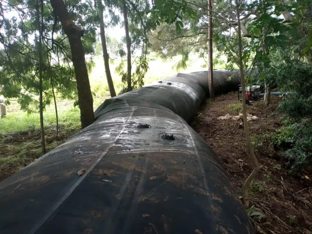 SLAMDAM flood barrier laid along the edge of a wood in Kenya